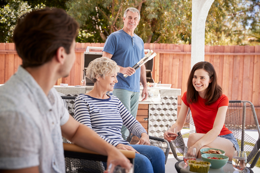 <p>Family having a cookout in a sunny backyard.</p>